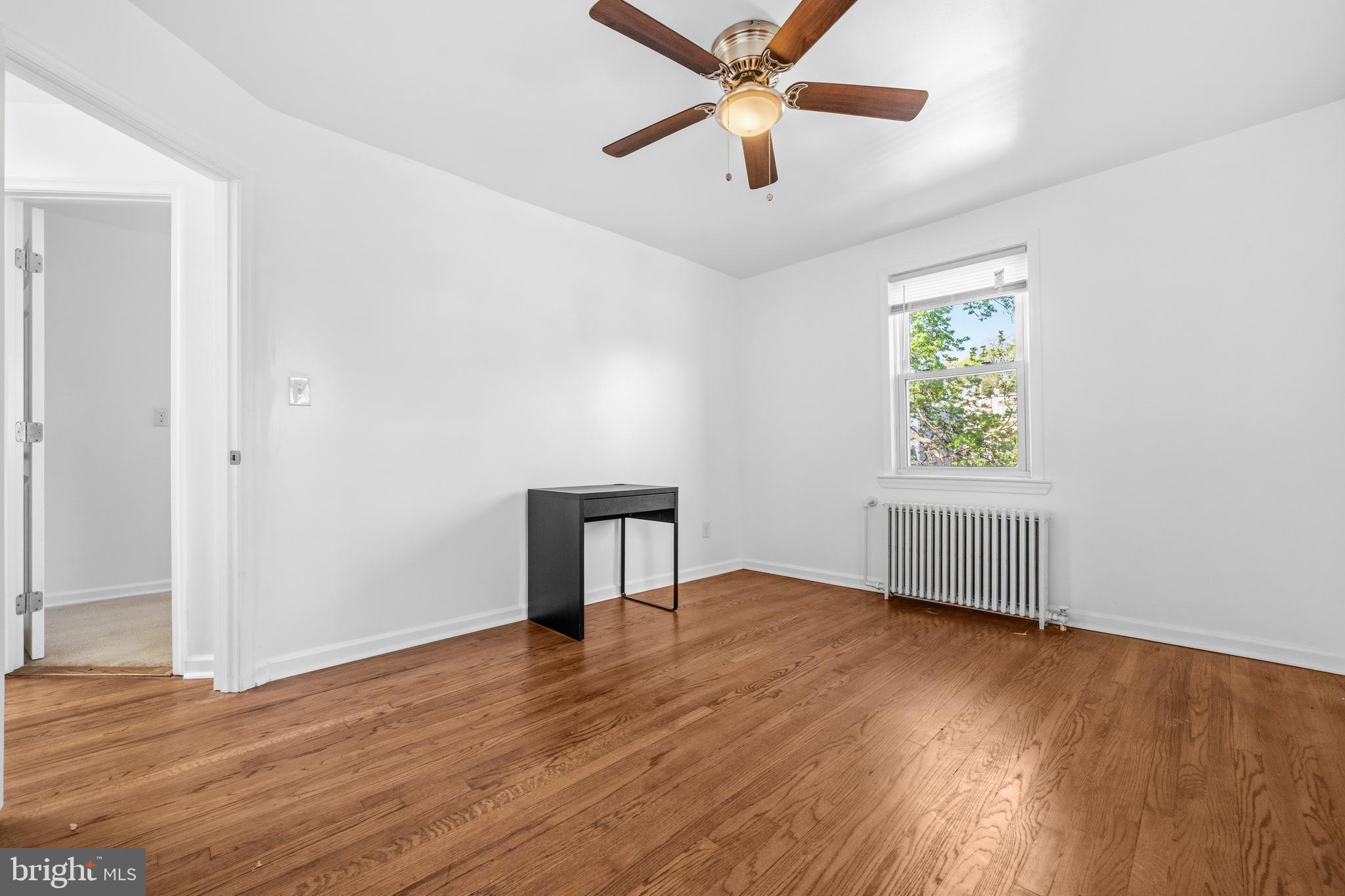 520 49th Street Northeast Washington, DC 20019 - Photo 15 of 38 an empty room with wooden floor fan and windows