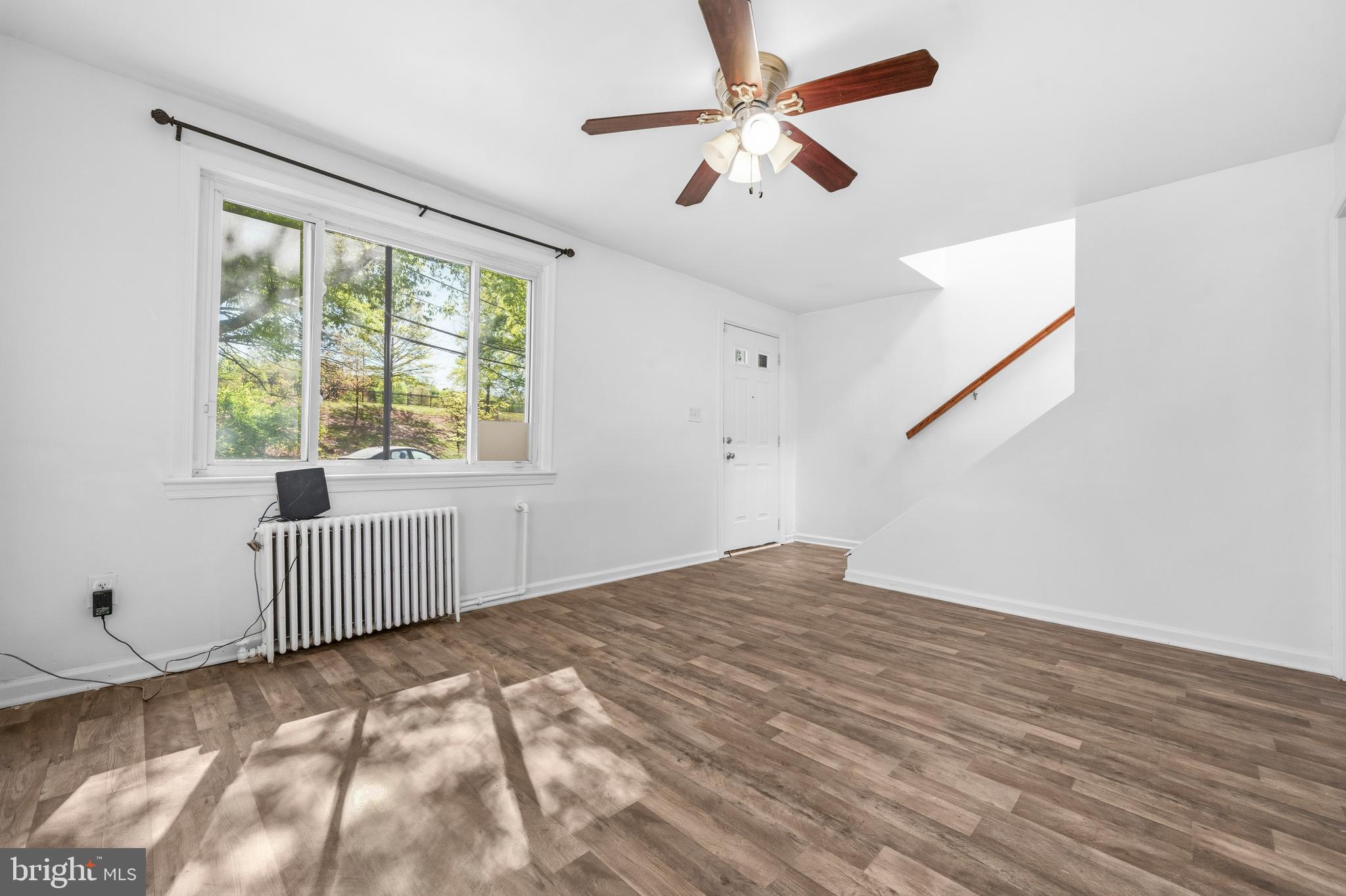 520 49th Street Northeast Washington, DC 20019 - Photo 6 of 38 a view of empty room with wooden floor and fan