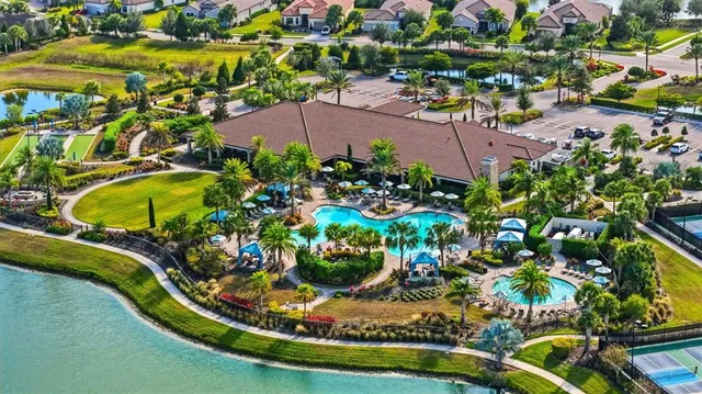 an aerial view of residential houses with outdoor space and swimming pool