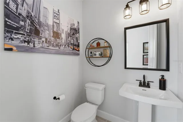 a view of kitchen with kitchen island stainless steel appliances refrigerator stove dining table and chairs
