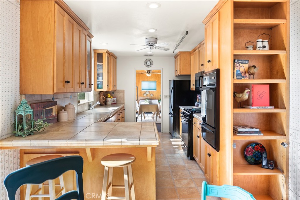 1075 Tracy Lane Chico, CA 95926 - Photo 13 of 29 a view of a kitchen with kitchen island granite countertop a refrigerator and a sink