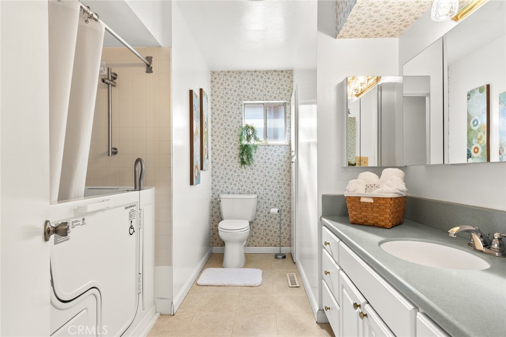 1075 Tracy Lane Chico, CA 95926 - Photo 23 of 29 a bathroom with a granite countertop sink and a mirror