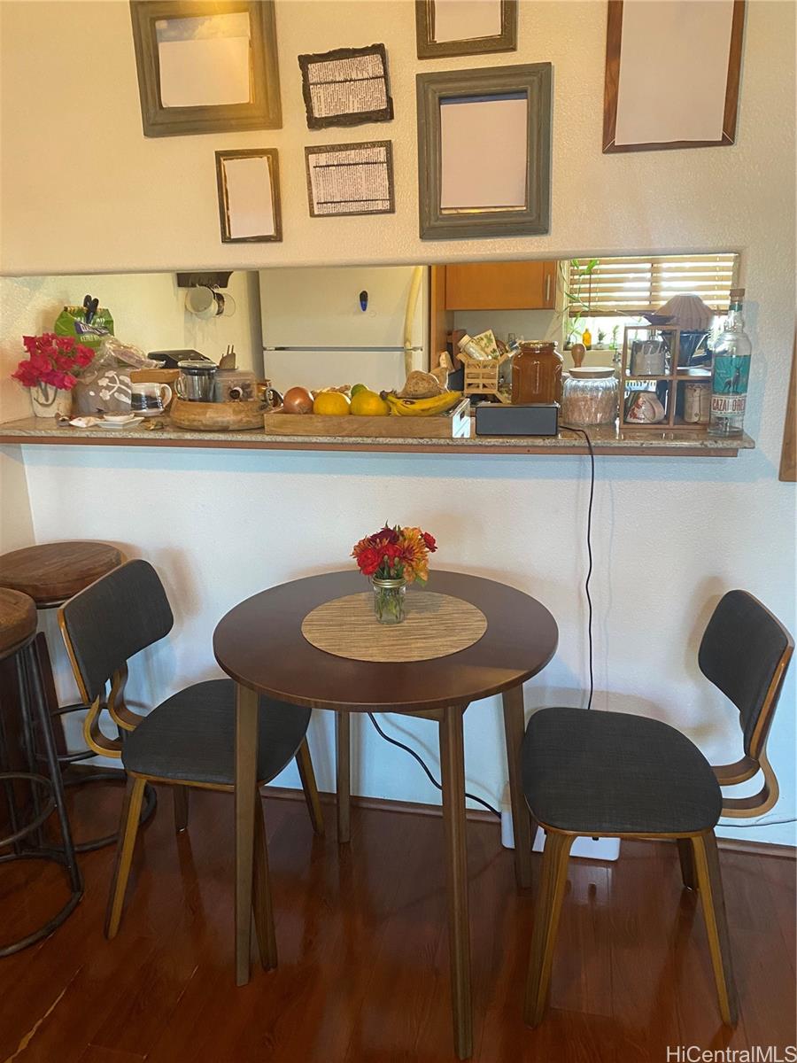 94-510 Lumiaina Street, Unit M103 Waipahu, HI 96797 - Photo 12 of 24 a kitchen with a table and chairs in it