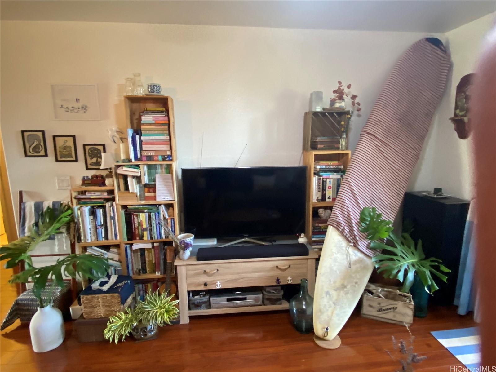 94-510 Lumiaina Street, Unit M103 Waipahu, HI 96797 - Photo 13 of 24 a living room with furniture and a flat screen tv