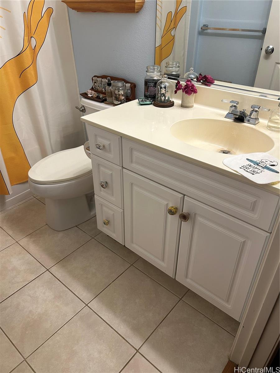 94-510 Lumiaina Street, Unit M103 Waipahu, HI 96797 - Photo 18 of 24 a bathroom with a sink and a toilet
