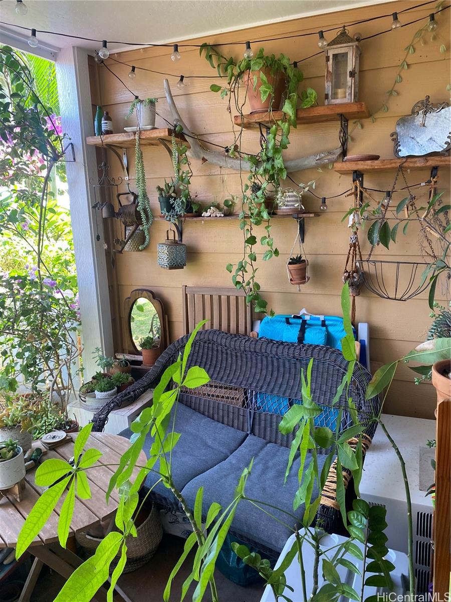 94-510 Lumiaina Street, Unit M103 Waipahu, HI 96797 - Photo 19 of 24 a view of a chairs and table in a patio