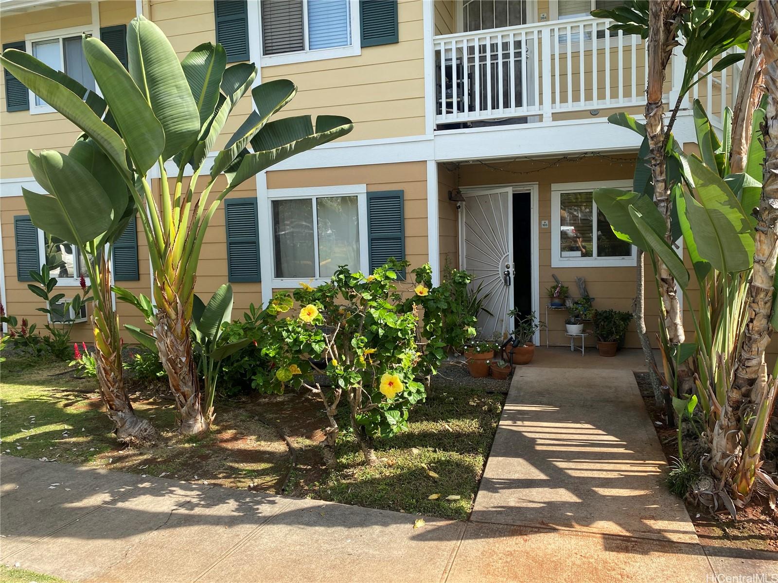 94-510 Lumiaina Street, Unit M103 Waipahu, HI 96797 - Photo 21 of 24 a view of a house with a window and flower plants