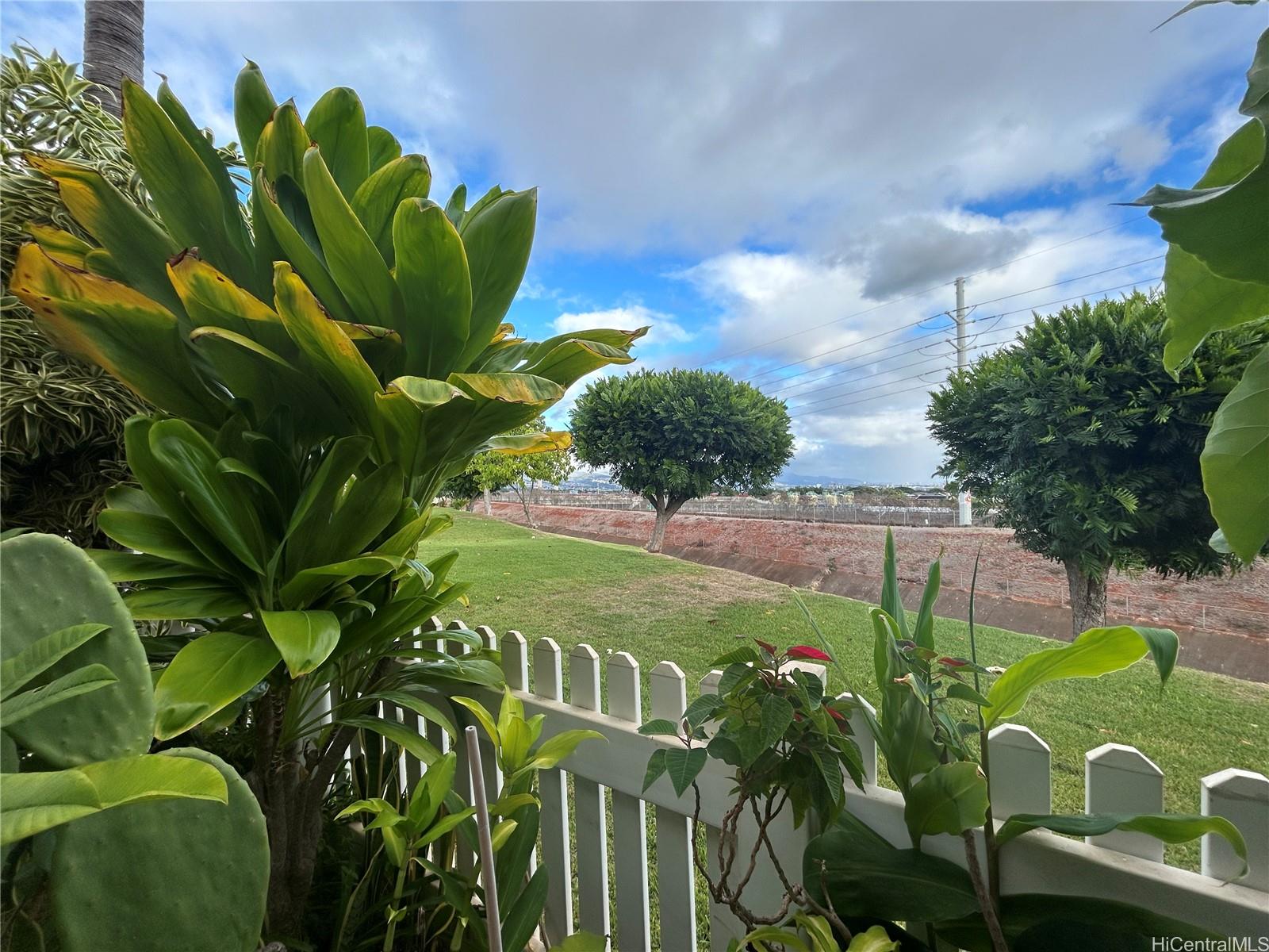 94-510 Lumiaina Street, Unit M103 Waipahu, HI 96797 - Photo 3 of 24 a green field with flowers