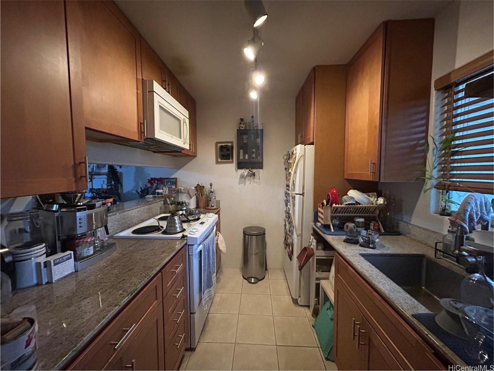 94-510 Lumiaina Street, Unit M103 Waipahu, HI 96797 - Photo 5 of 24 a kitchen with a sink stove and refrigerator