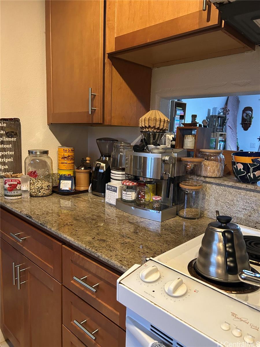 94-510 Lumiaina Street, Unit M103 Waipahu, HI 96797 - Photo 6 of 24 a kitchen with a sink a stove and cabinets