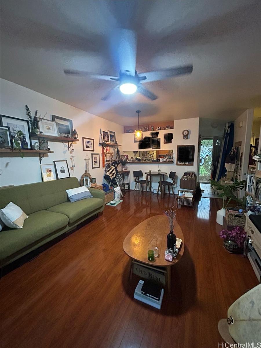 94-510 Lumiaina Street, Unit M103 Waipahu, HI 96797 - Photo 7 of 24 a room with furniture and a wooden floor