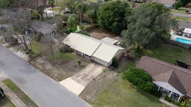an aerial view of a house with a yard and street