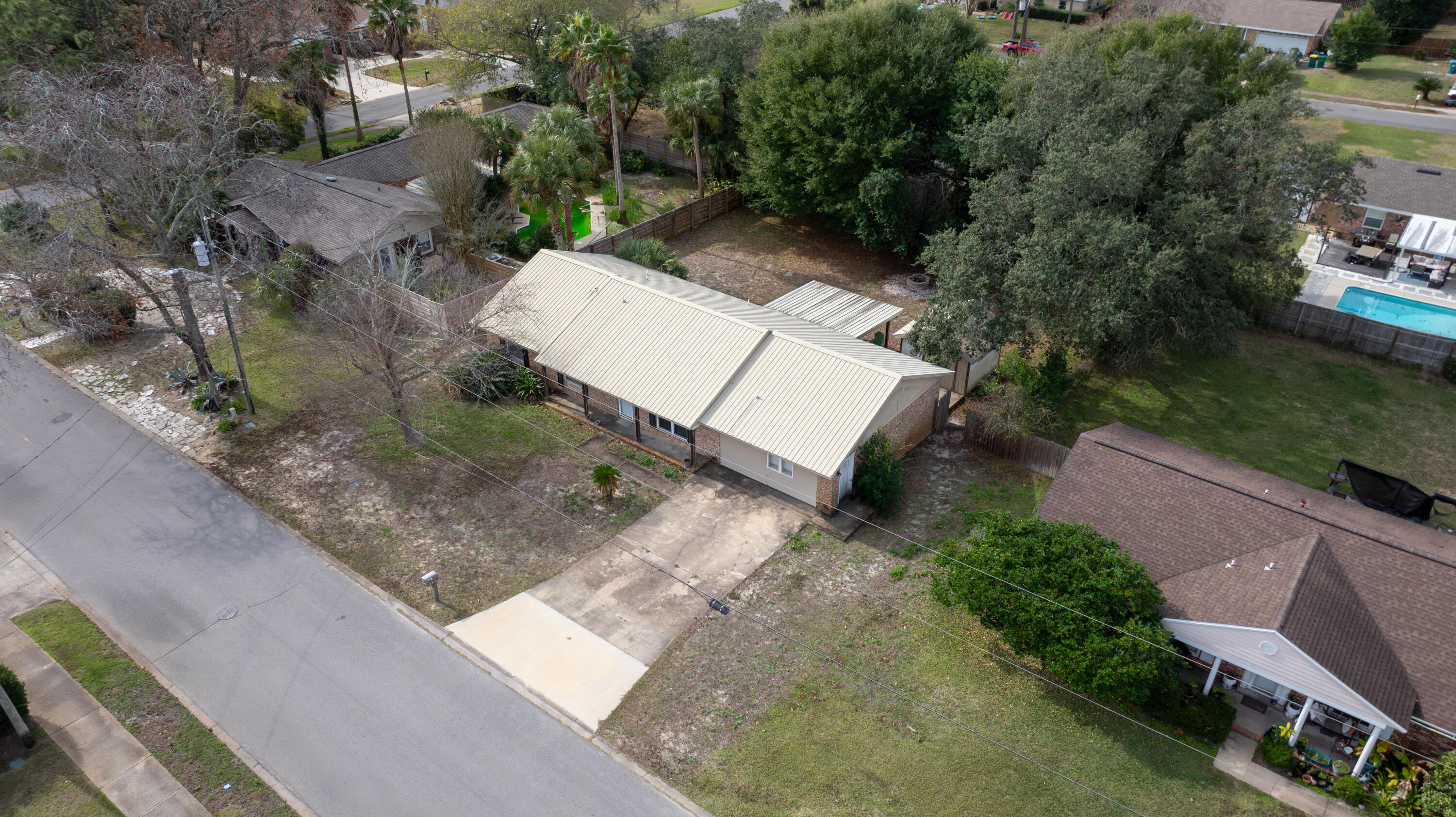 307 Spring Lane Destin, FL 32541 - Photo 3 of 42 an aerial view of a house with a yard and street