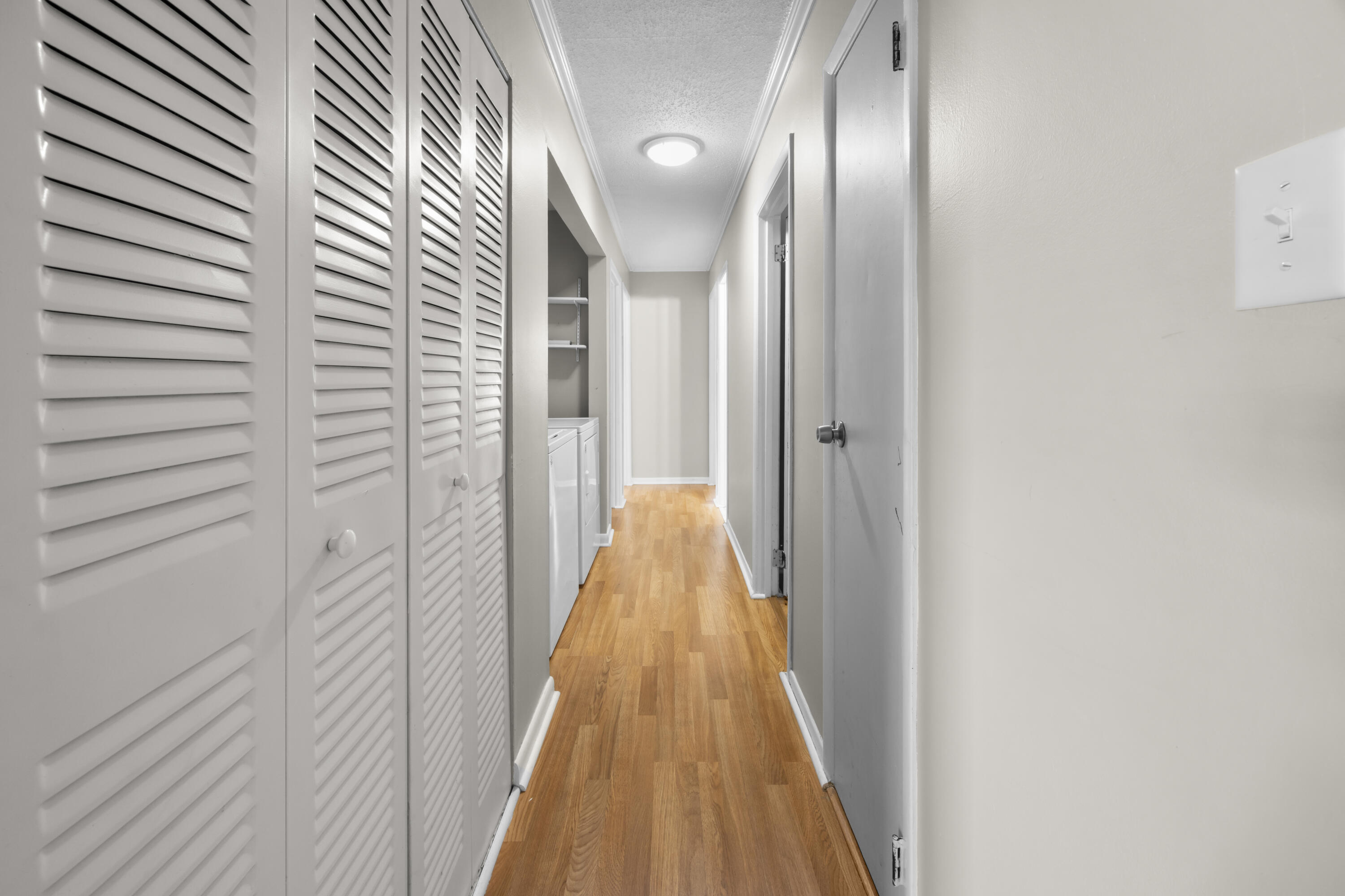 307 Spring Lane Destin, FL 32541 - Photo 36 of 42 a view of a hallway with wooden floor
