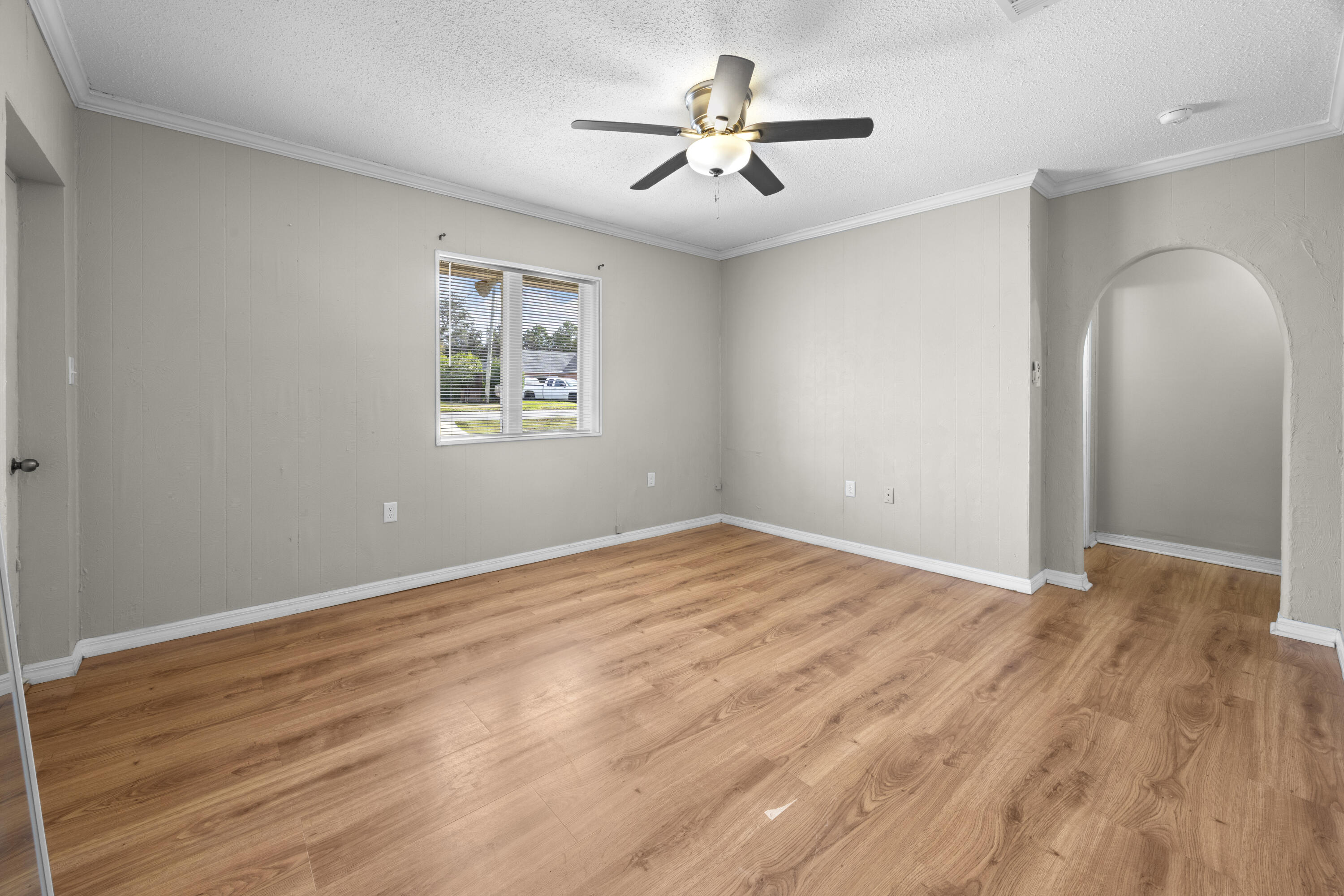307 Spring Lane Destin, FL 32541 - Photo 39 of 42 a view of an empty room with a window and wooden floor