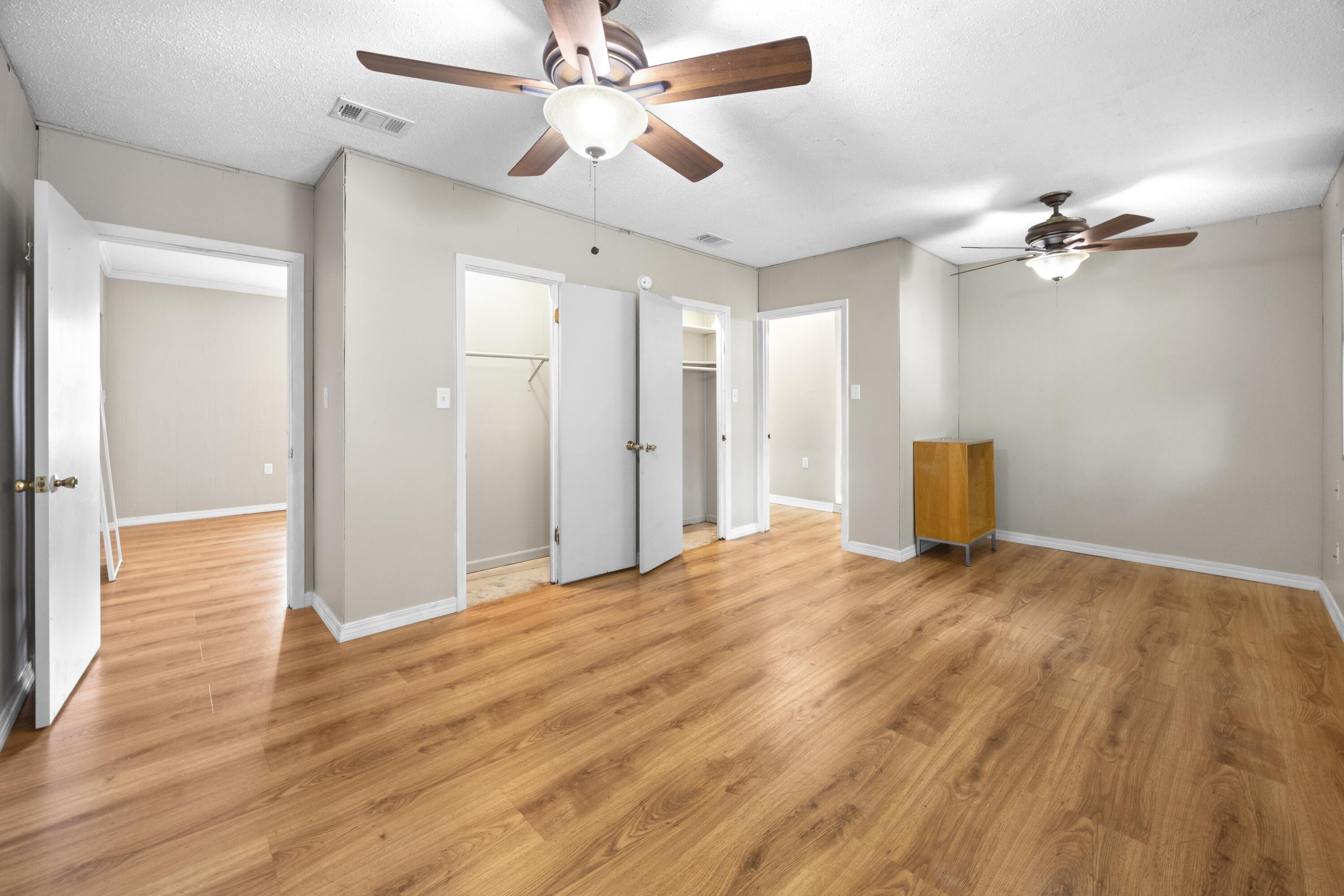 307 Spring Lane Destin, FL 32541 - Photo 40 of 42 a view of empty room with wooden floor and fan