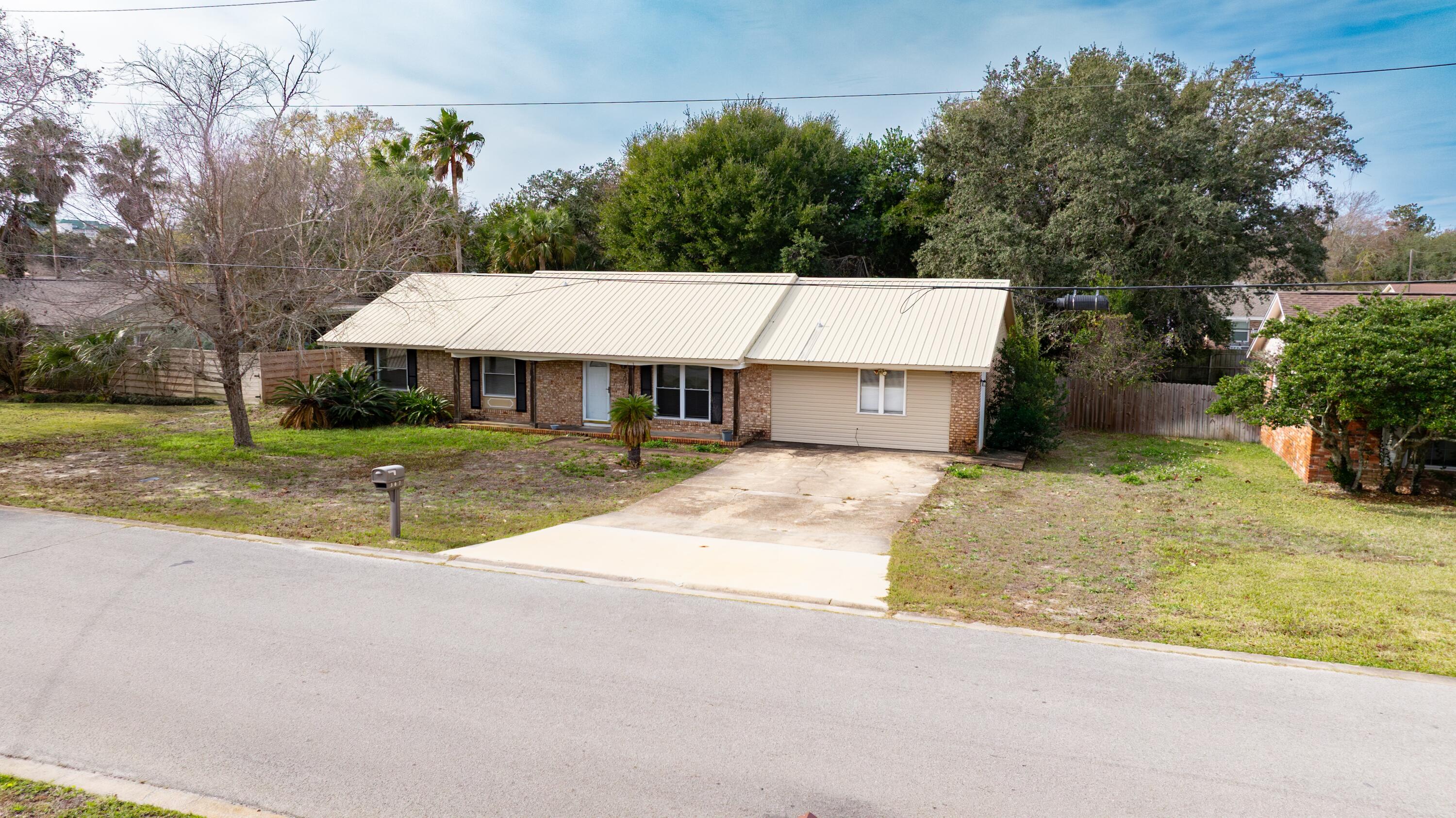 307 Spring Lane Destin, FL 32541 - Photo 6 of 42 a view of house with yard and tree in front of it