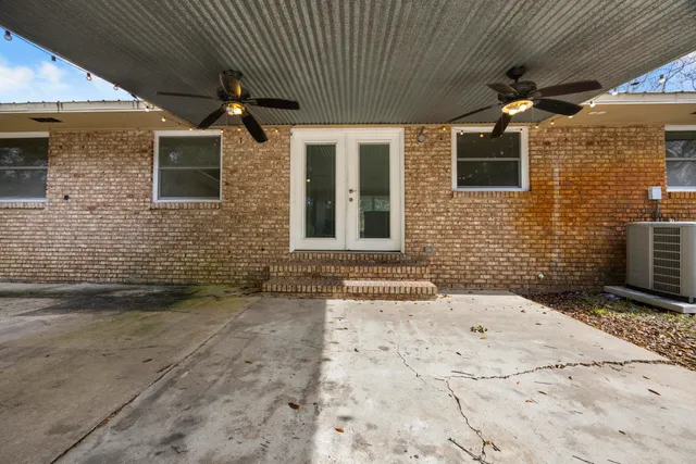 a kitchen with granite countertop a stove a sink and a refrigerator