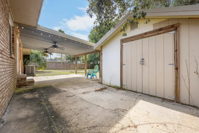 a view of a big room with wooden floor and windows