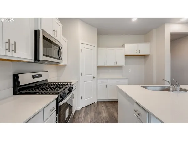 a open kitchen with kitchen island a sink stove and refrigerator