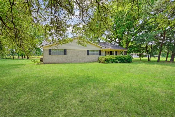 a front view of house with yard and green space