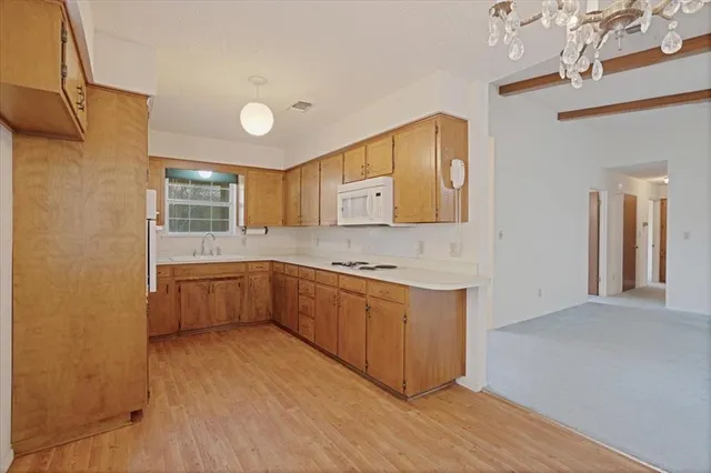 a kitchen with stainless steel appliances granite countertop a sink and cabinets