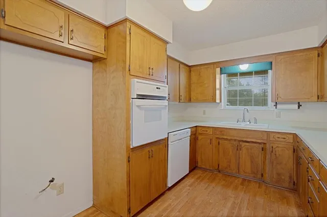 a view of livingroom with hardwood floor and kitchen view