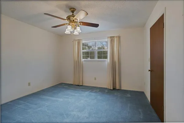 a view of an empty room with a fan