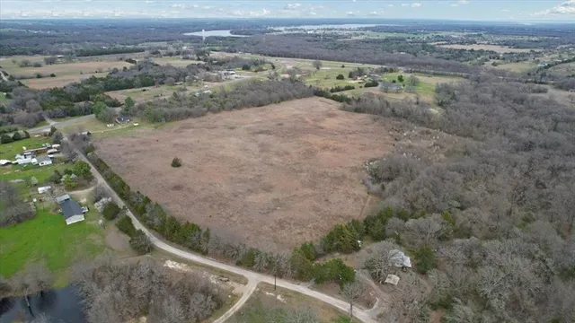 a view of a field with mountains in the background