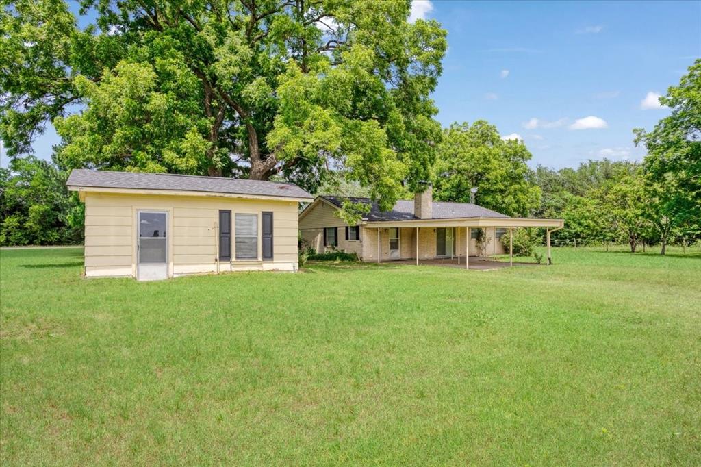4400 Highway 121 Bonham, TX 75418 - Photo 5 of 40 a front view of a house with a garden