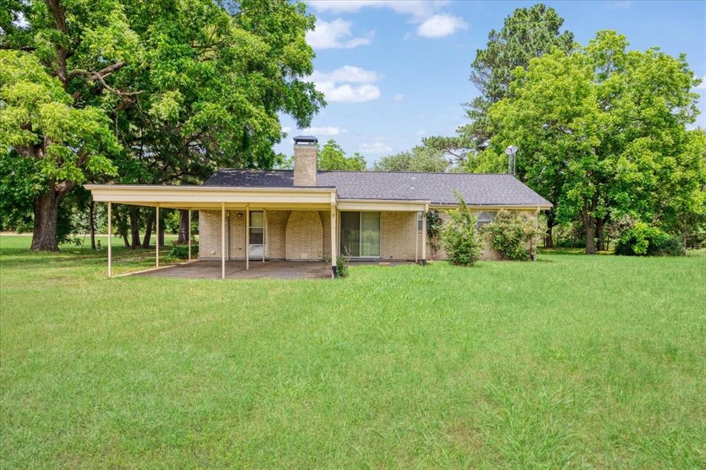 4400 Highway 121 Bonham, TX 75418 - Photo 7 of 40 a view of a yard with plants and large trees