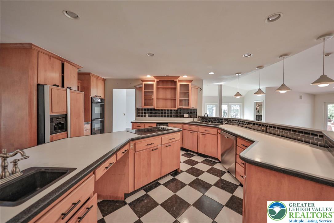 1015 Honeysuckle Road Walnutport, PA 18088 - Photo 11 of 75 a large kitchen with stainless steel appliances a sink and a counter top space