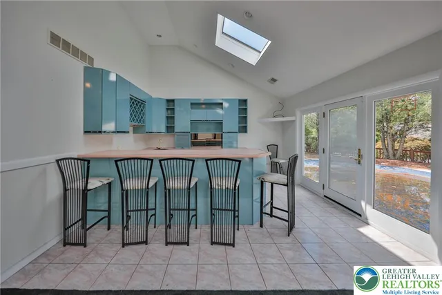 a large kitchen with stainless steel appliances a stove a sink dishwasher and a refrigerator