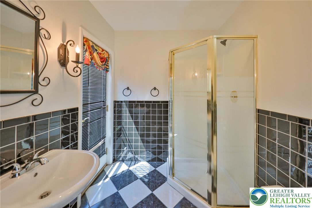 1015 Honeysuckle Road Walnutport, PA 18088 - Photo 30 of 75 a bathroom with a sink and a shower