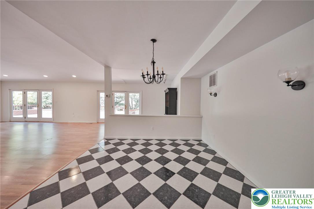 1015 Honeysuckle Road Walnutport, PA 18088 - Photo 32 of 75 a view of a living room with a black white checkered floor
