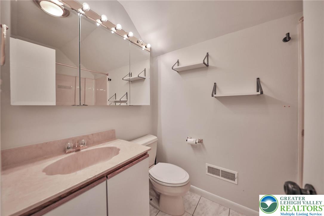 1015 Honeysuckle Road Walnutport, PA 18088 - Photo 44 of 75 a bathroom with a sink toilet and a mirror