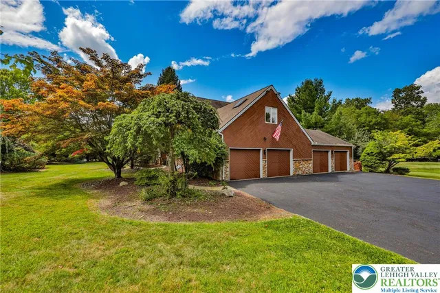 a large kitchen with stainless steel appliances a sink and a counter top space