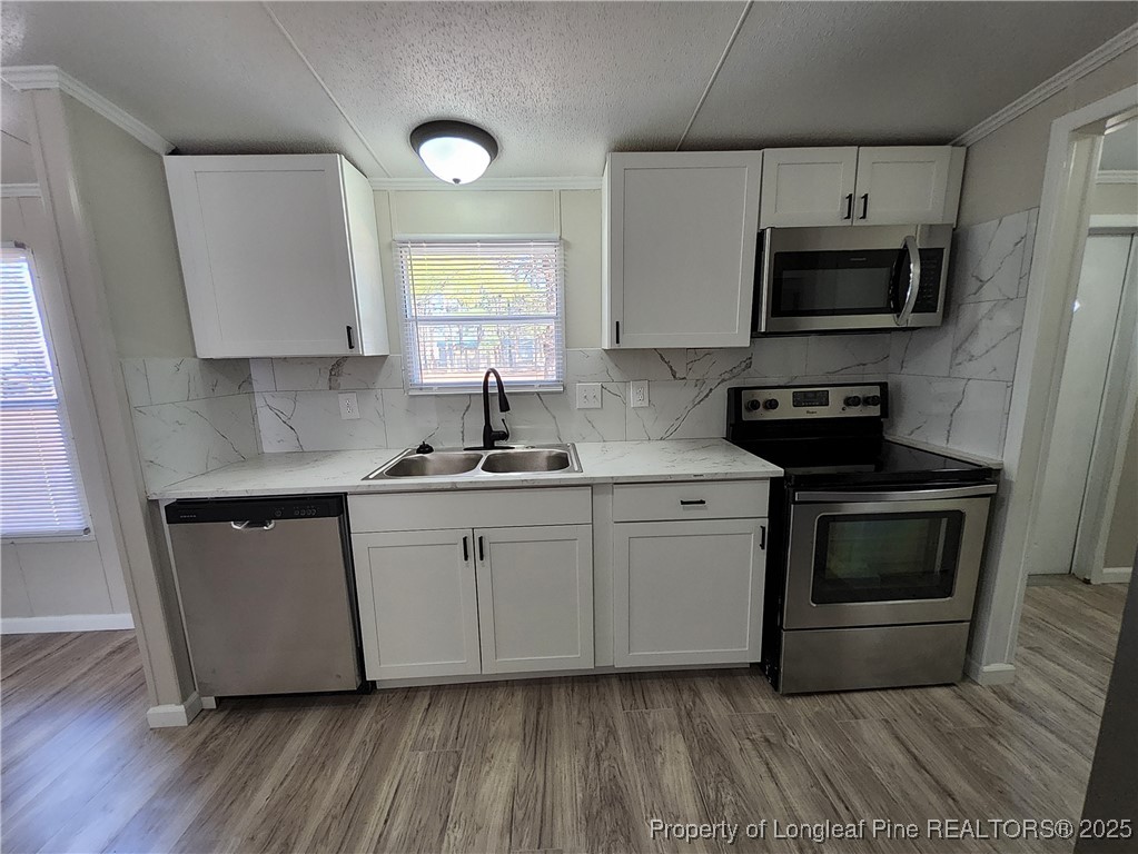 87 Drox Lane Clinton, NC 28328 - Photo 11 of 22 a kitchen with granite countertop a sink cabinets and stainless steel appliances
