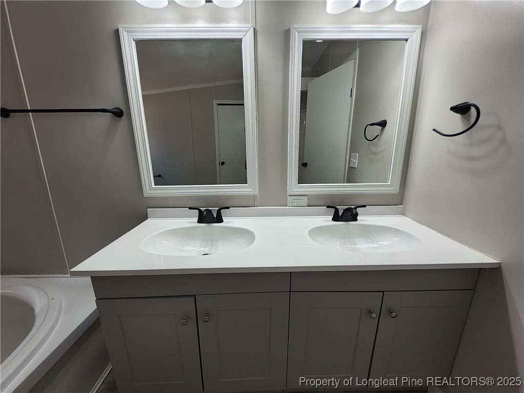 87 Drox Lane Clinton, NC 28328 - Photo 21 of 22 a bathroom with a sink and a mirror