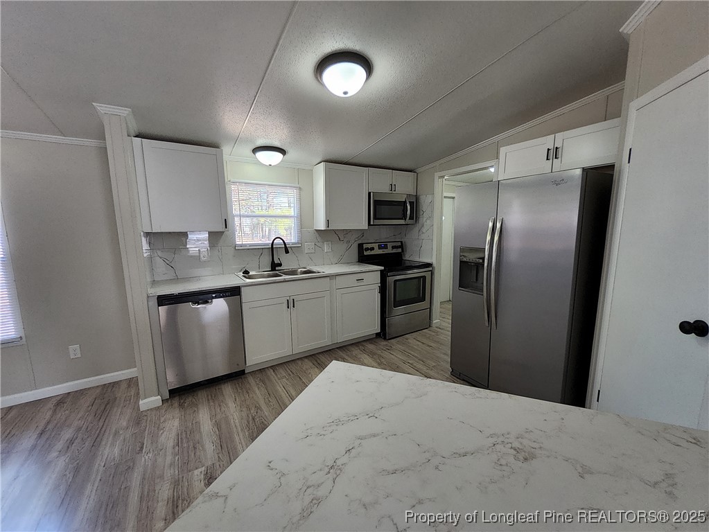 87 Drox Lane Clinton, NC 28328 - Photo 9 of 22 a kitchen with stainless steel appliances granite countertop a sink refrigerator and cabinets