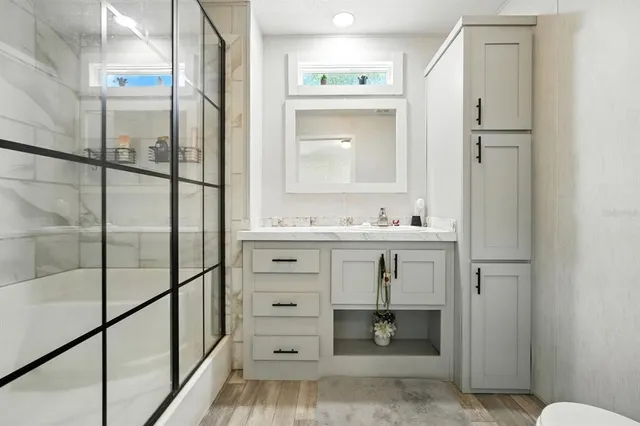 a bathroom with a sink a toilet and a mirror