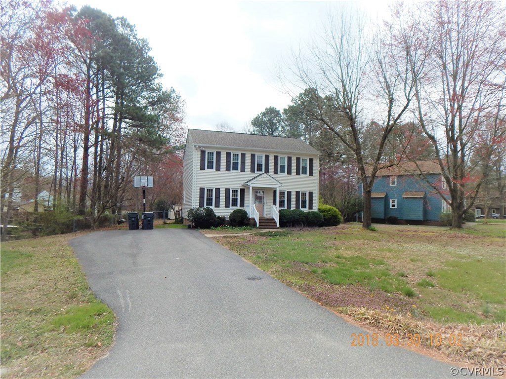 a view of a house with a yard next to a road