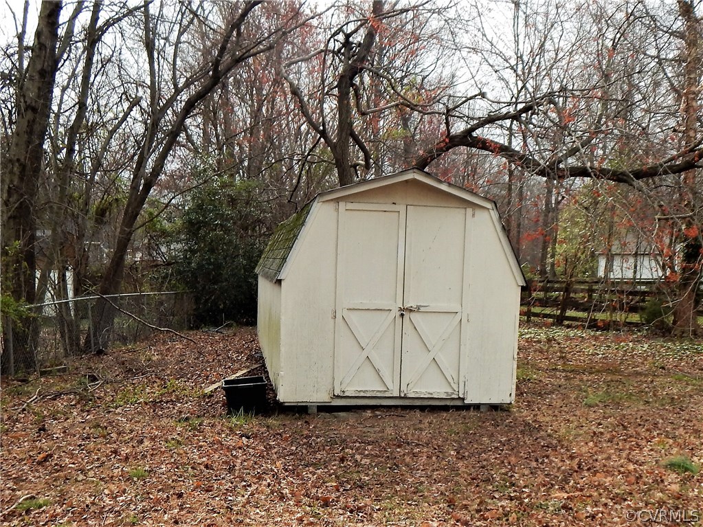 1427 Austin Road Chester, VA 23836 - Photo 5 of 5 a wooden house with trees in front of it