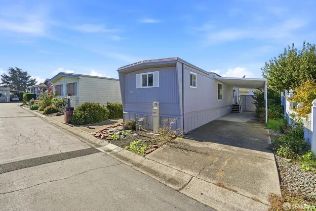 a backyard of a house with yard and outdoor seating