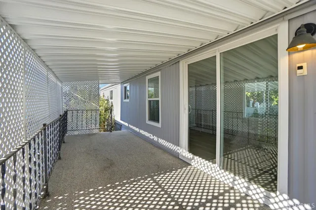 a view of empty room with wooden floor and window