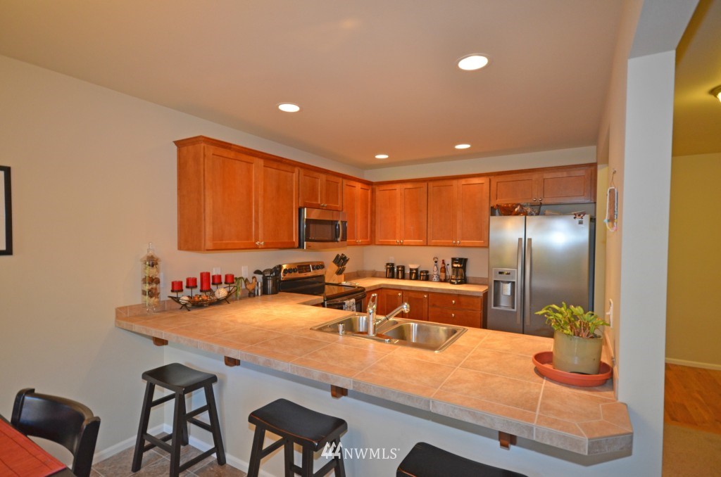 11 194th Street Southwest Bothell, WA 98012 - Photo 3 of 10 a kitchen with granite countertop a sink and cabinets