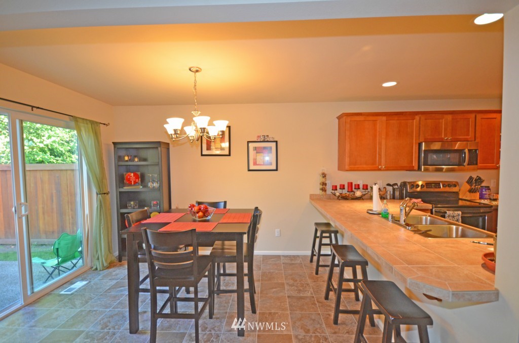 11 194th Street Southwest Bothell, WA 98012 - Photo 4 of 10 a dining room with furniture a chandelier and window