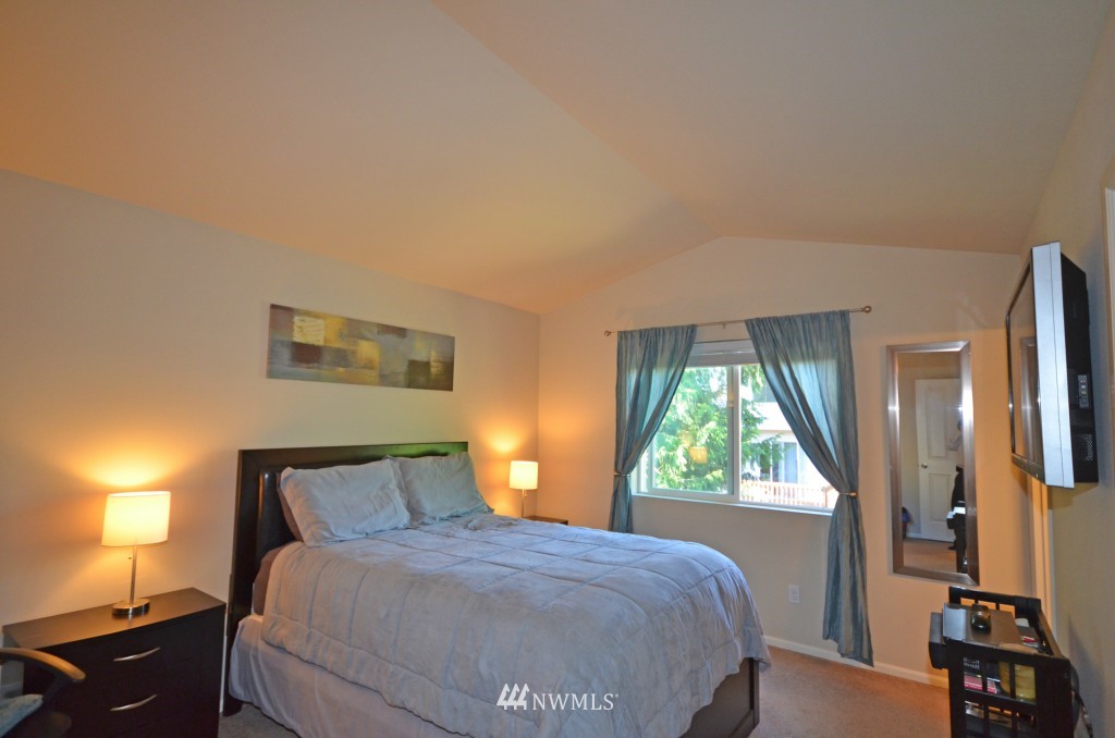 11 194th Street Southwest Bothell, WA 98012 - Photo 9 of 10 a bedroom with a bed and a large window