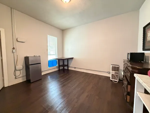 a view of a livingroom with workspace and a couch