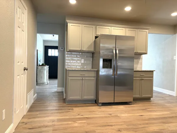 a view of an empty room with wooden floor